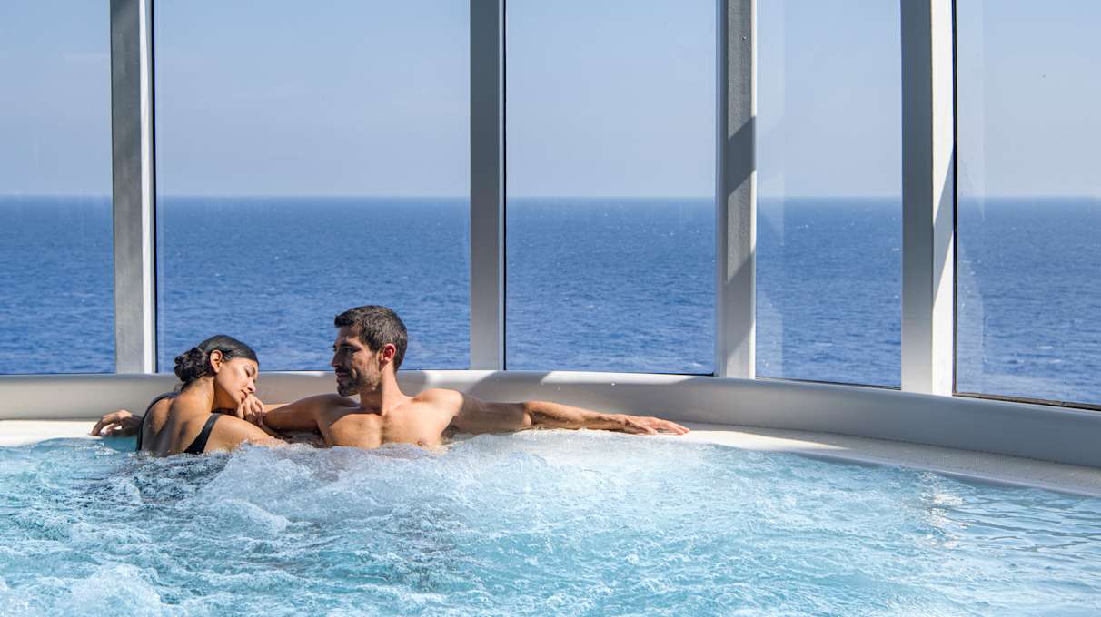 A couple relaxing in a hot tub on a MSC Cruise ship
